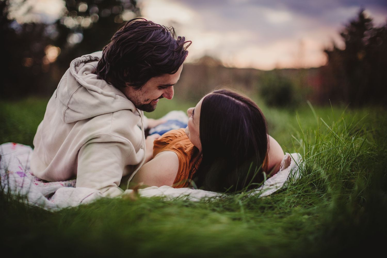 An intimate portrait session outdoors with soft natural lighting and candid expressions.