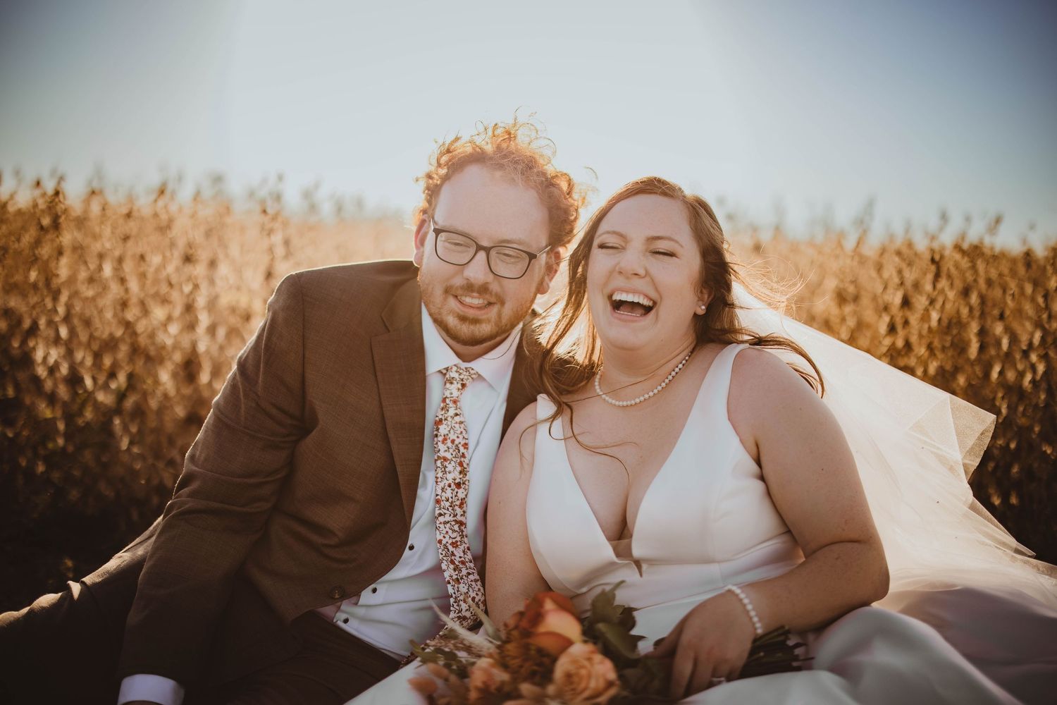 Joyful wedding portraits taken during sunset with beautiful natural lighting and autumn colors.