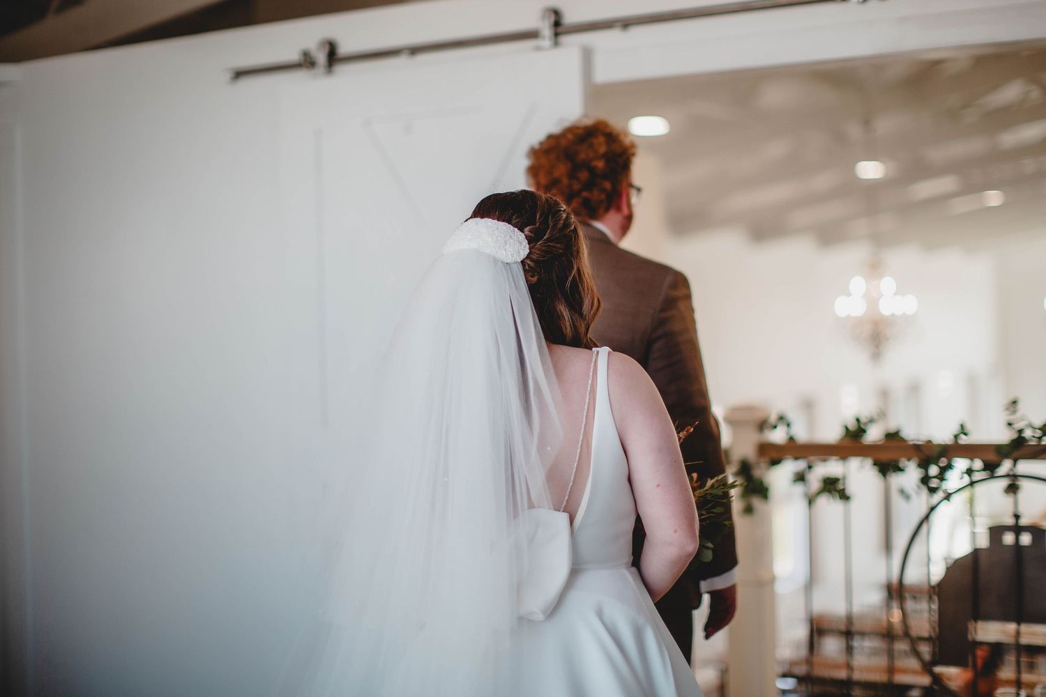 A wedding venue interior decorated with soft lighting and elegant floral arrangements.