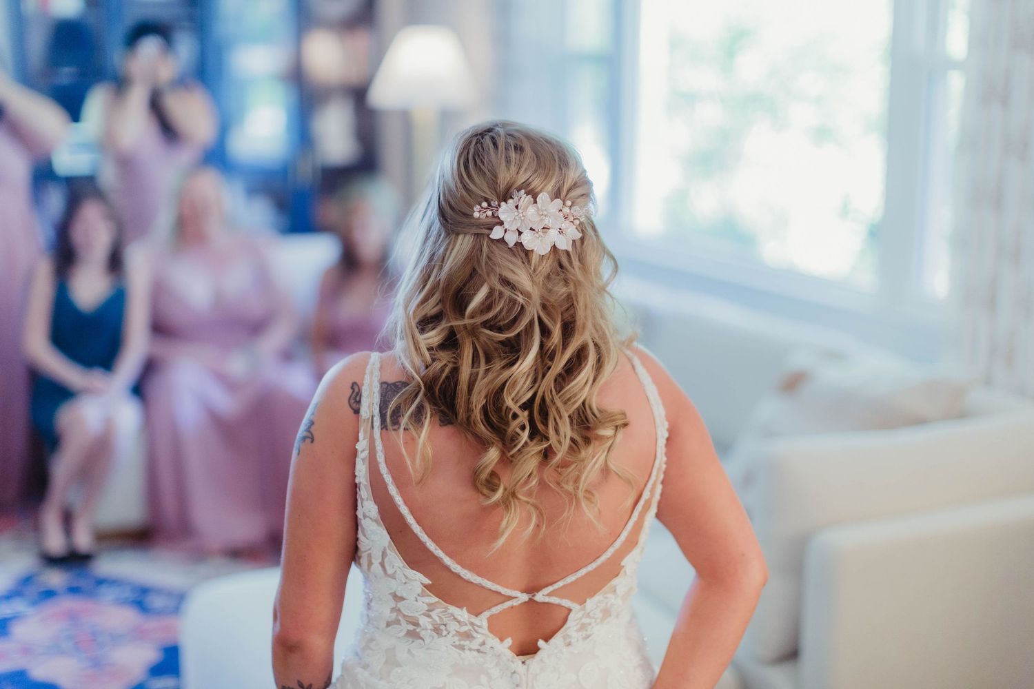 Back view of wedding dress showing detailed lace and cross-strap design.