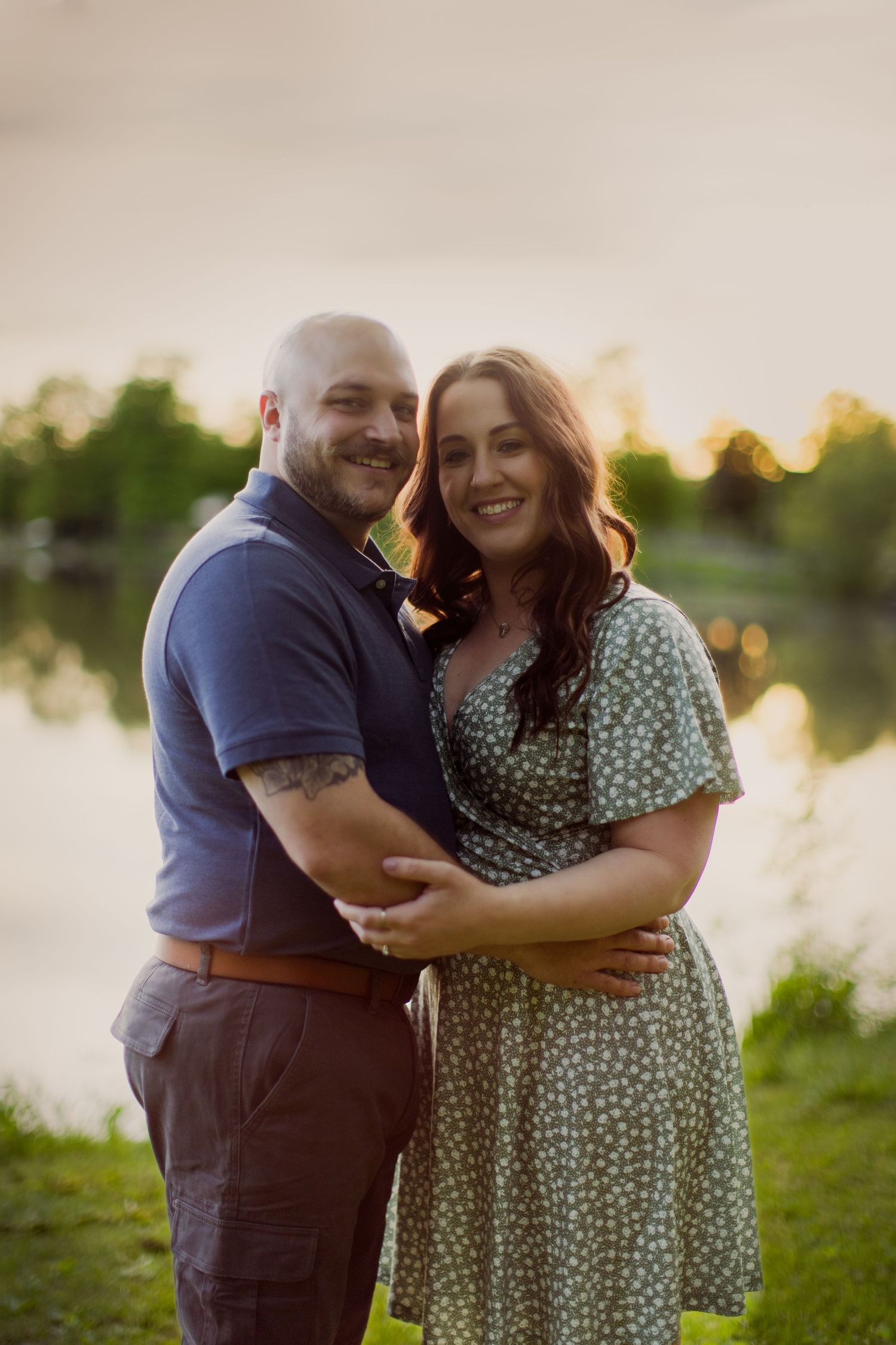 Happy couple shares authentic moment of joy during golden hour photo session.