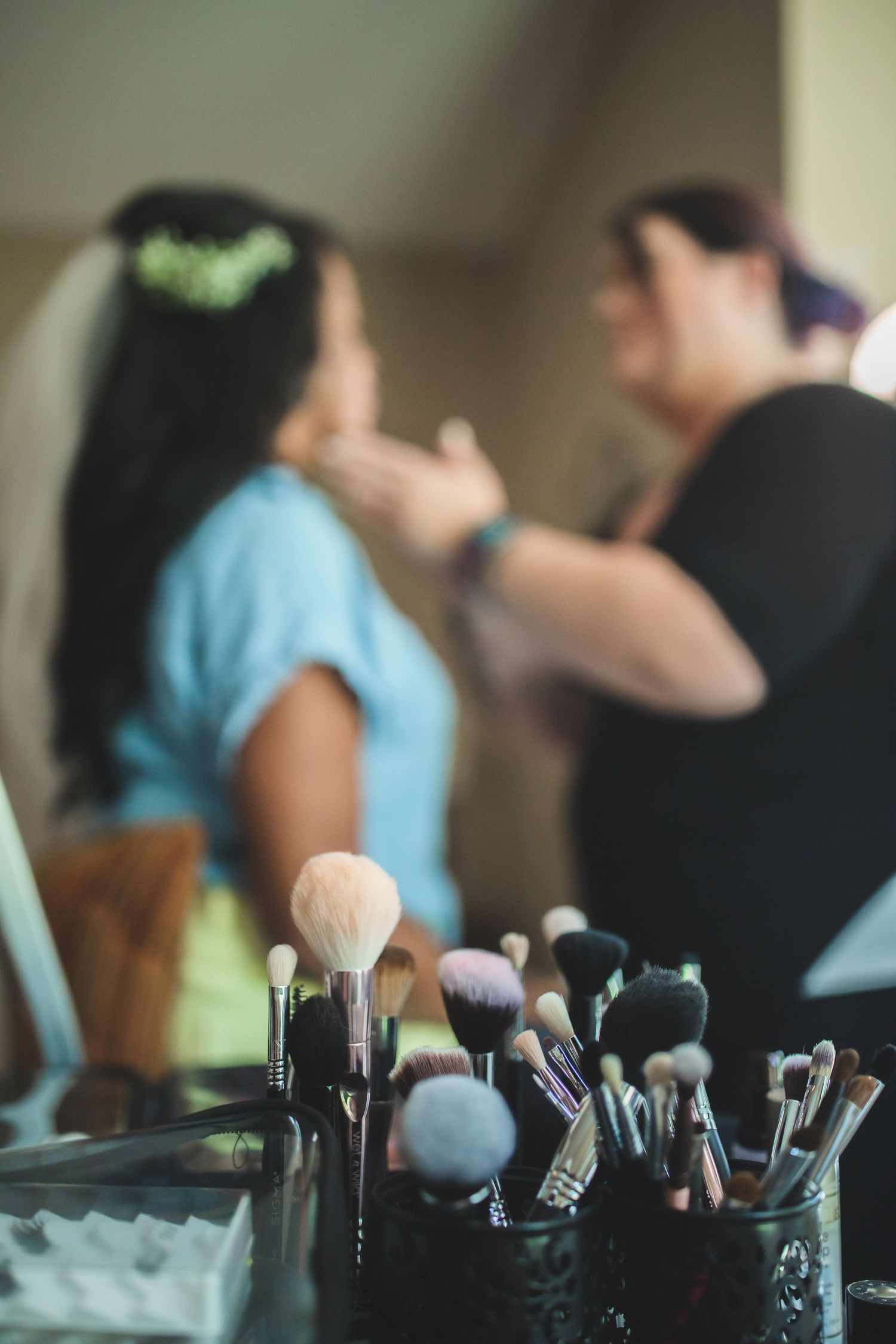 Wedding makeup station with brushes while final bridal preparations continue.