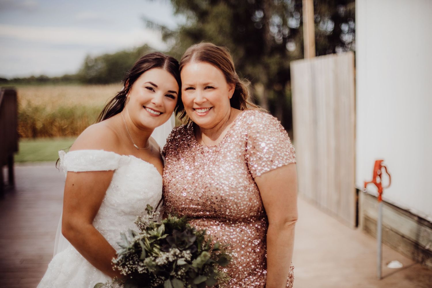 Candid moments shared between wedding party members in rose gold and white attire.