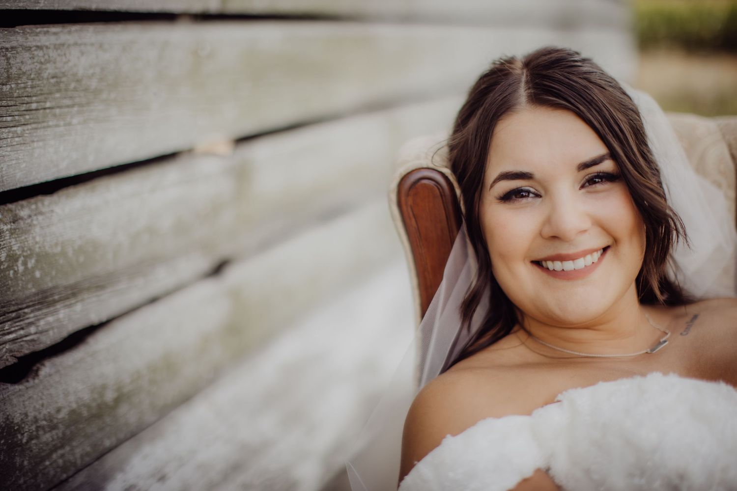 Intimate bridal portrait with rustic wooden wall backdrop.
