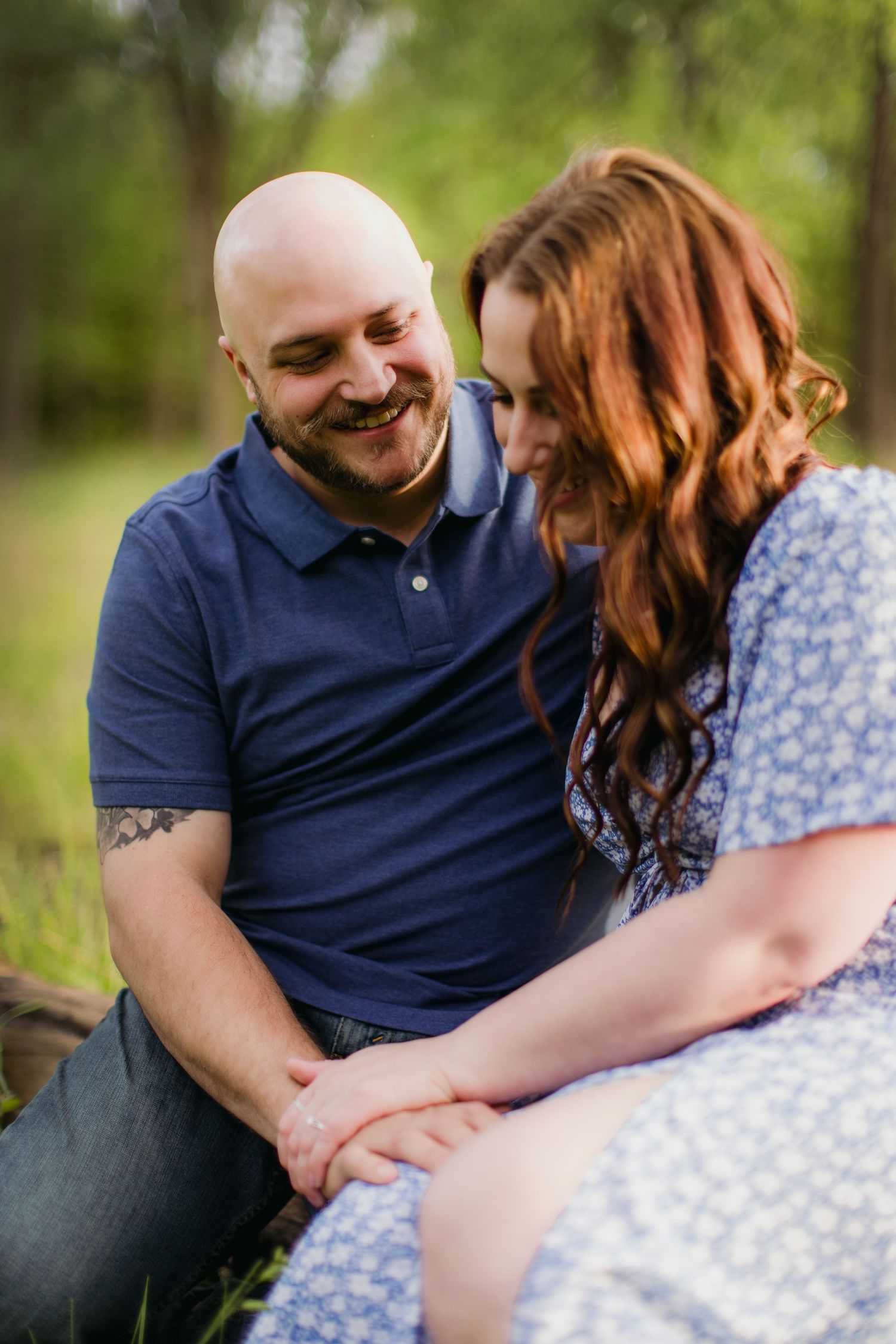 Heartfelt portrait of a couple laughing together while sitting outdoors.