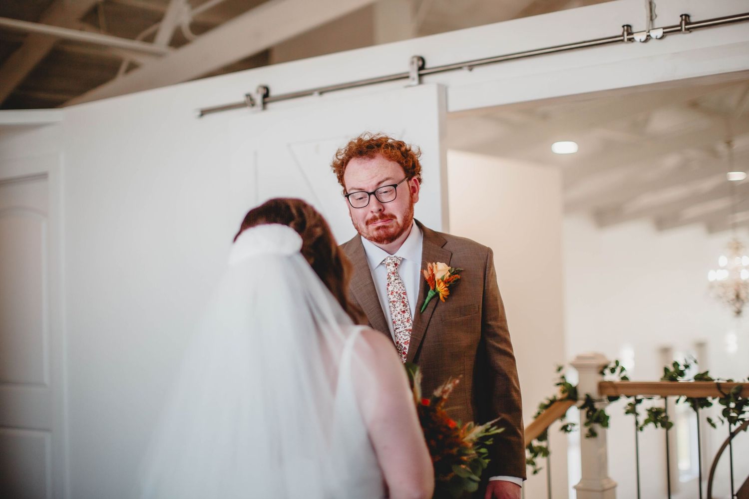 A modern wedding venue with industrial-style ceiling and romantic floral decor.