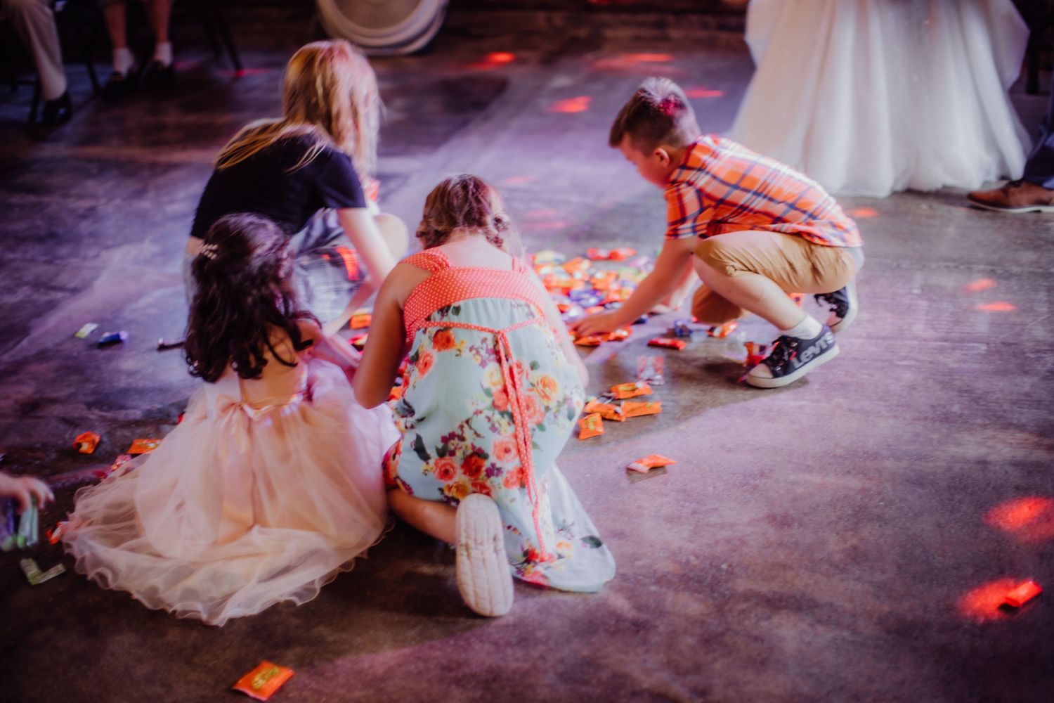 Wedding guests enjoying a lively dance floor moment in a rustic barn venue.