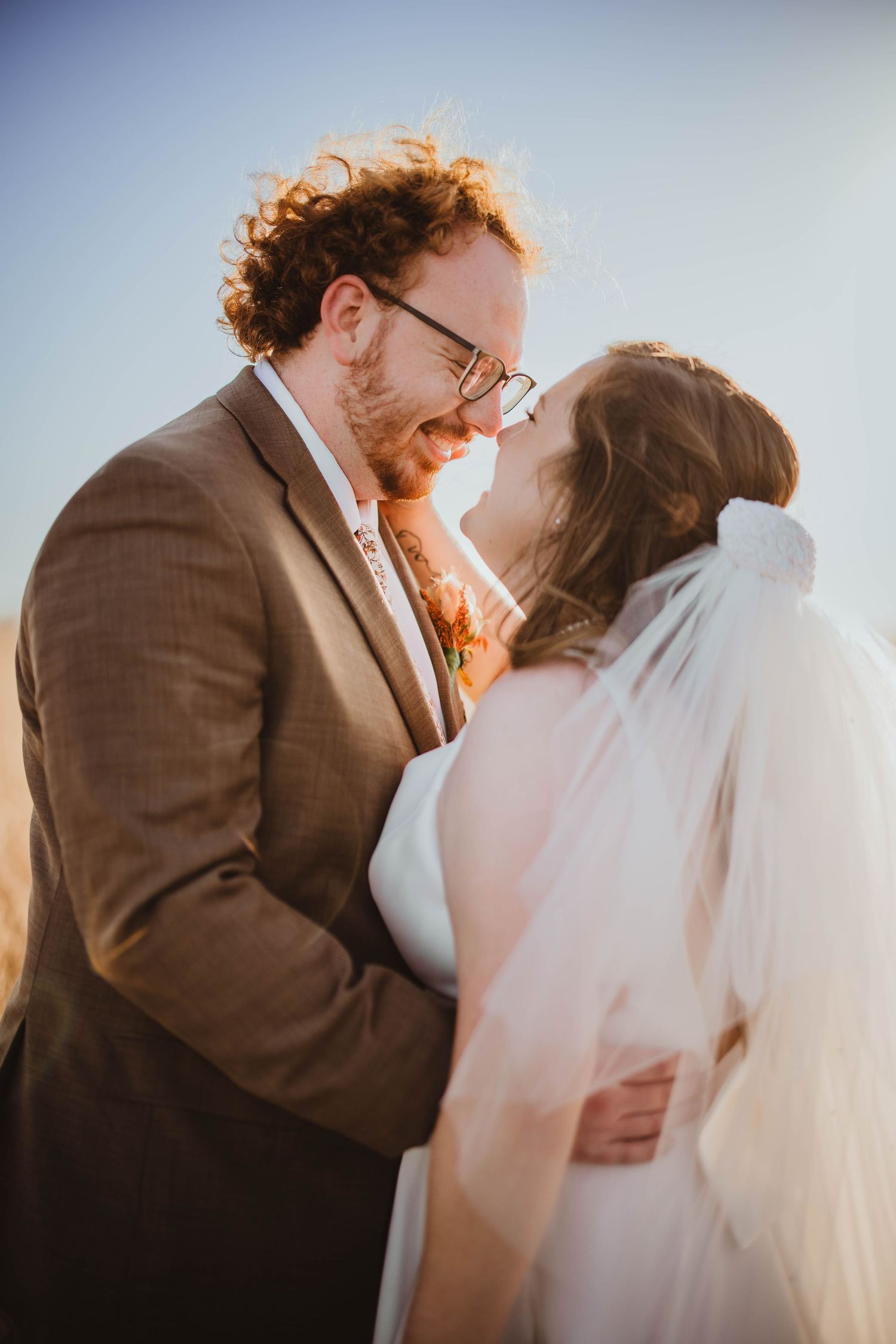 Romantic wedding photos capturing candid moments between newlyweds in soft natural light.