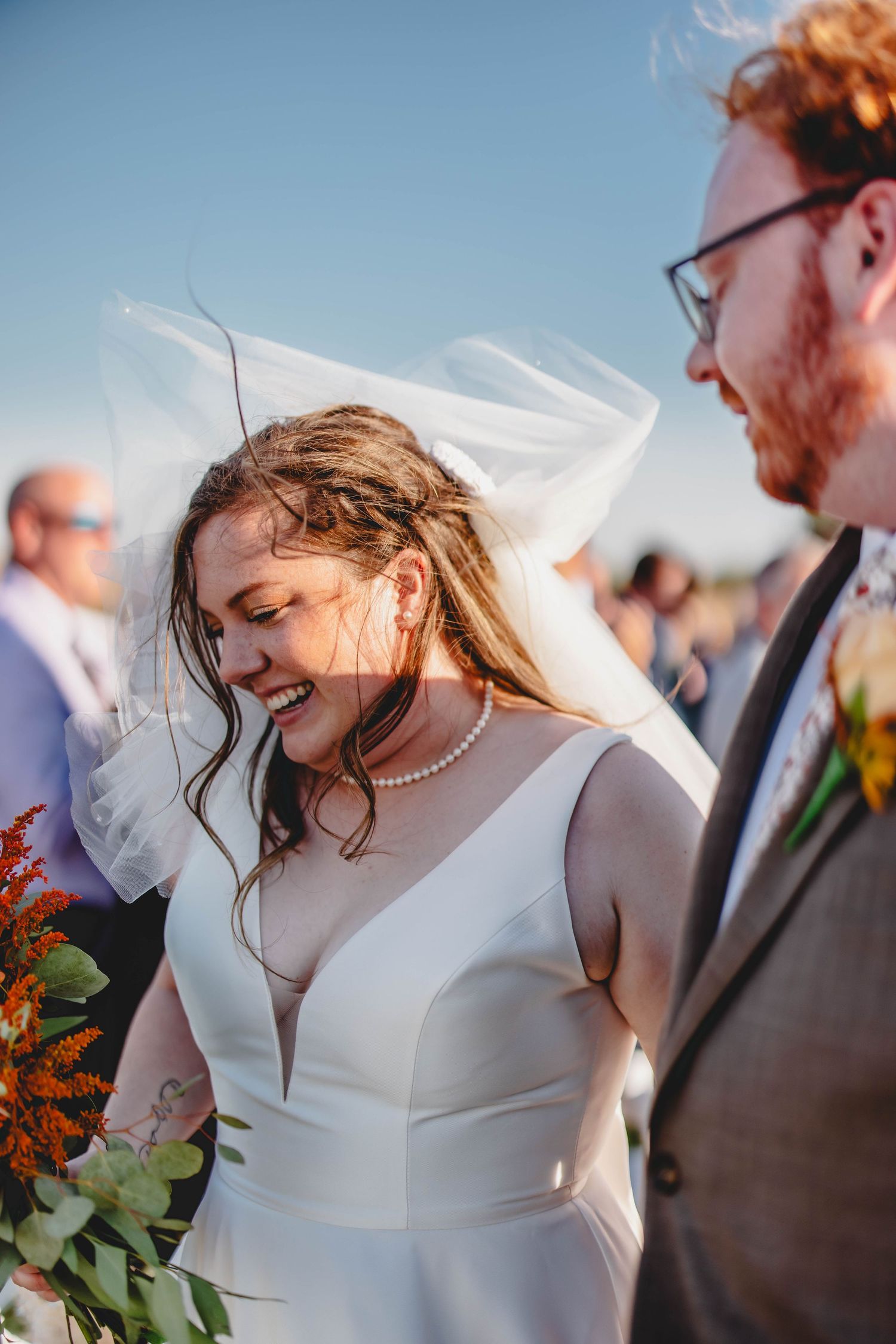 Candid moment of joy between couple during wedding ceremony exit.