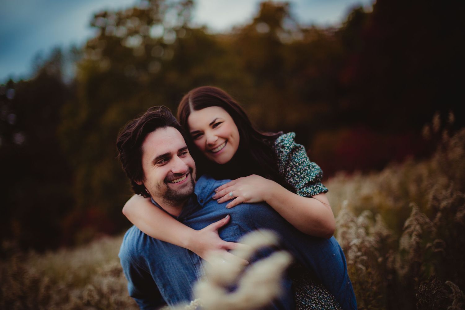 Couple in casual attire sharing playful moments in an outdoor setting.