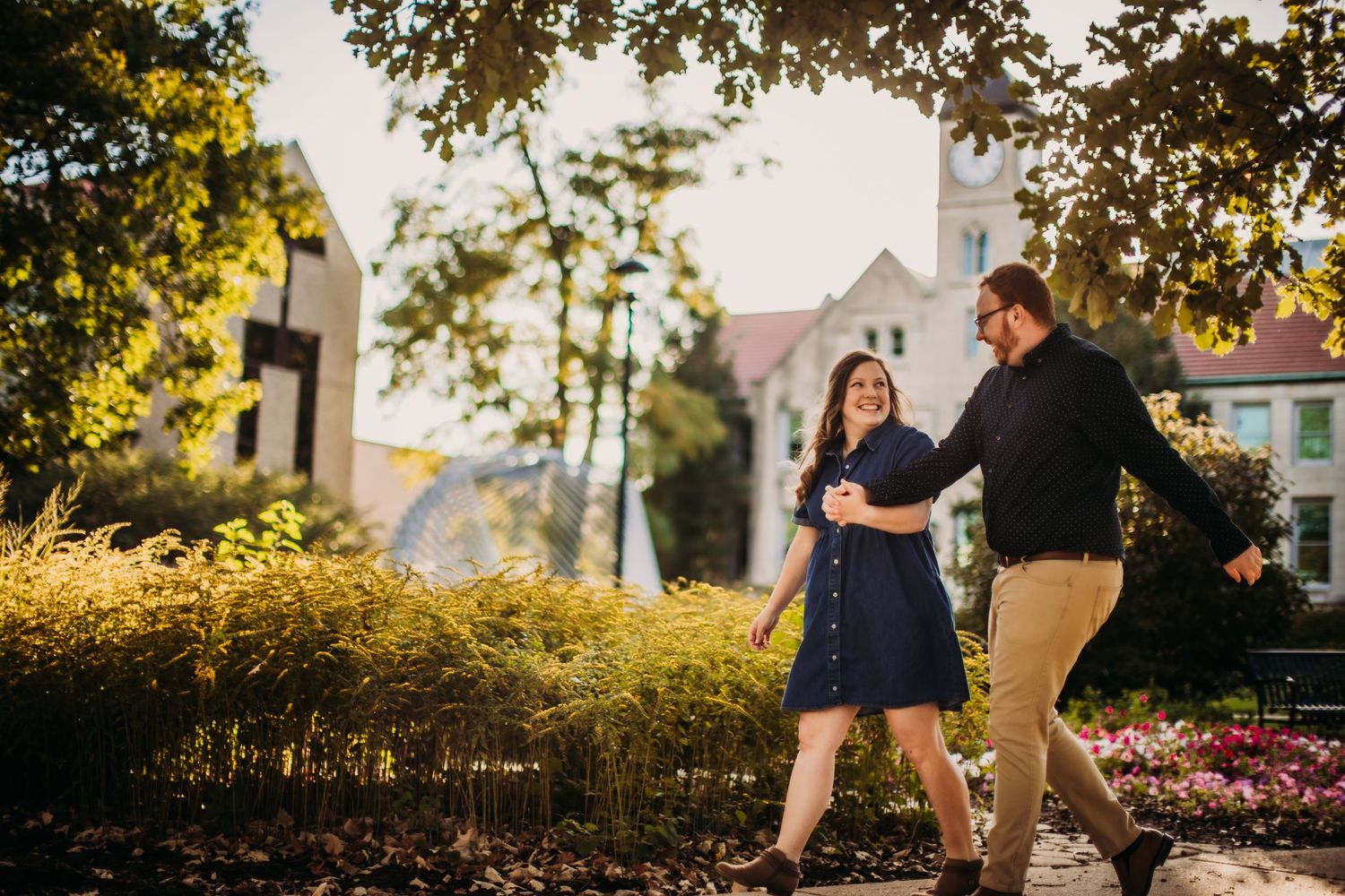 Intimate couple photoshoot in an outdoor setting with autumn trees.