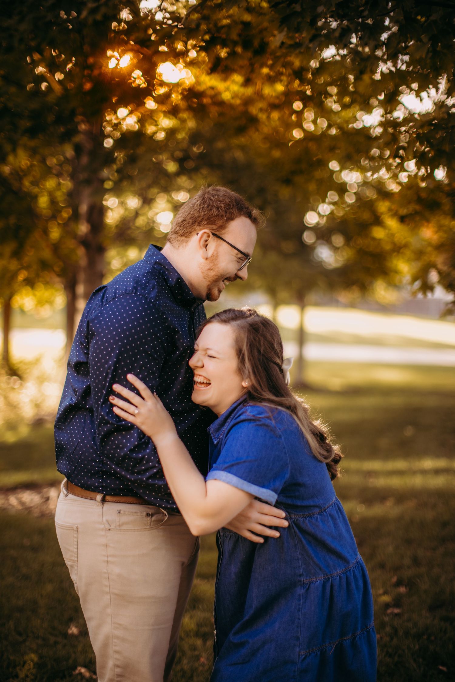 Intimate autumn engagement session in park during golden hour.