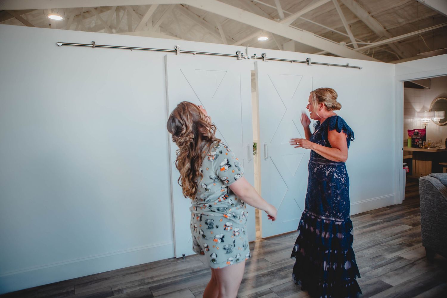 A series of emotional first look wedding photos showing two people reacting with joy in a bright indoor venue.