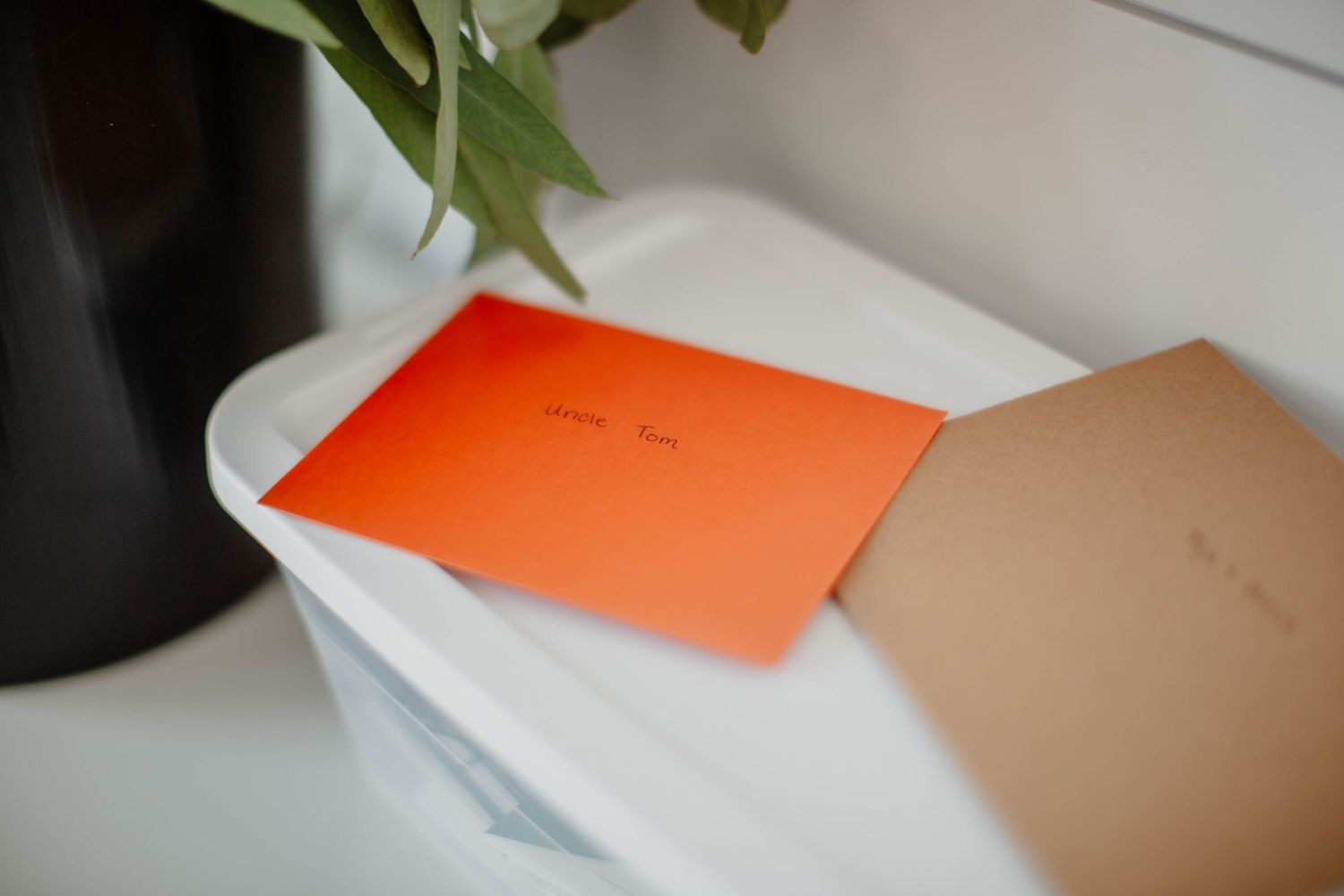 Orange notebook and papers arranged on a clean white surface.