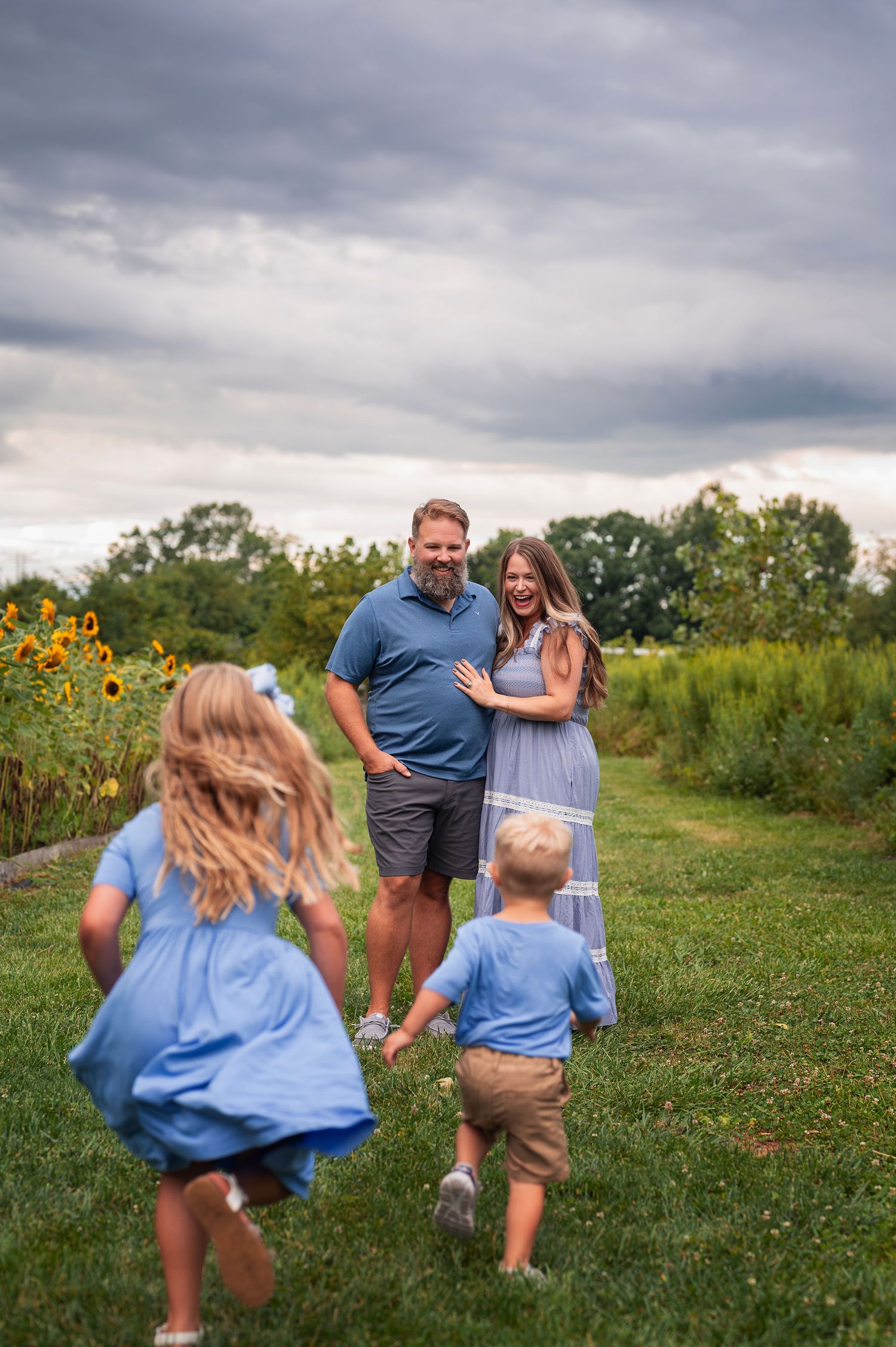 Westerville Ohio family photo session at a sunflower farm with kids running to parents—Boundless Joy Photography