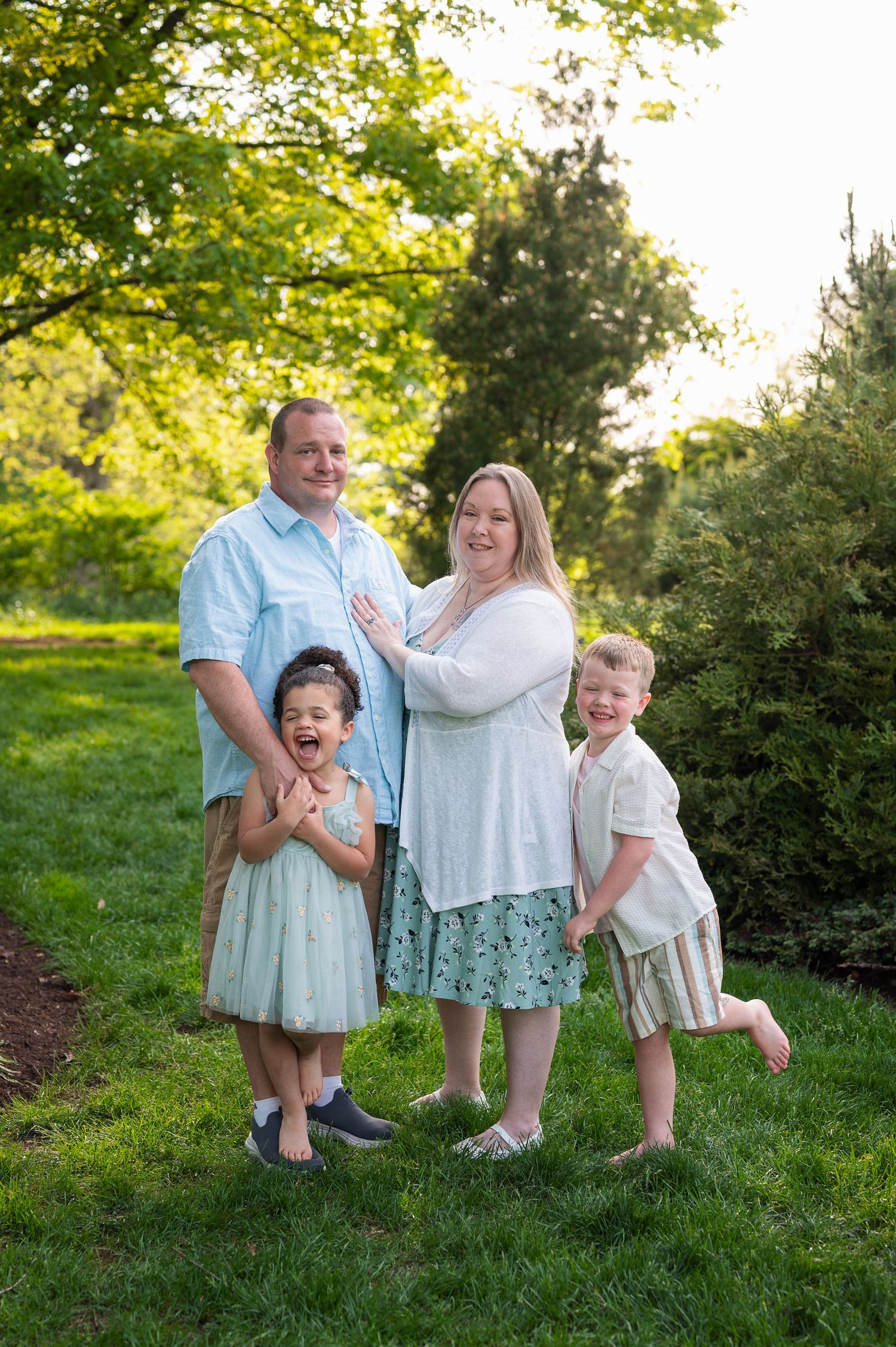 Toddler removing shoes during family session at Franklin Park