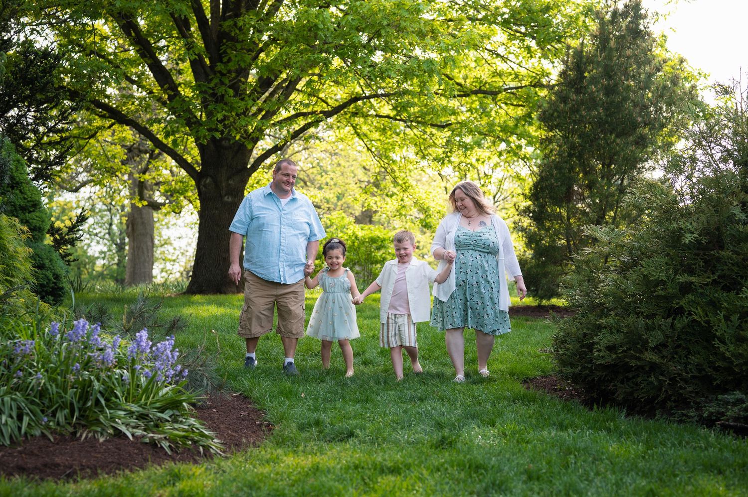 Walking hand-in-hand during a spring photo session at Franklin Park