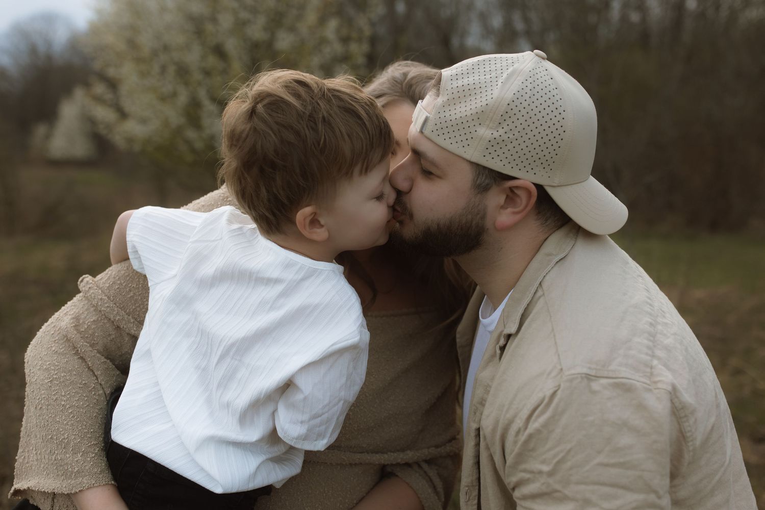 A tender moment shared between parent and child in warm outdoor lighting.