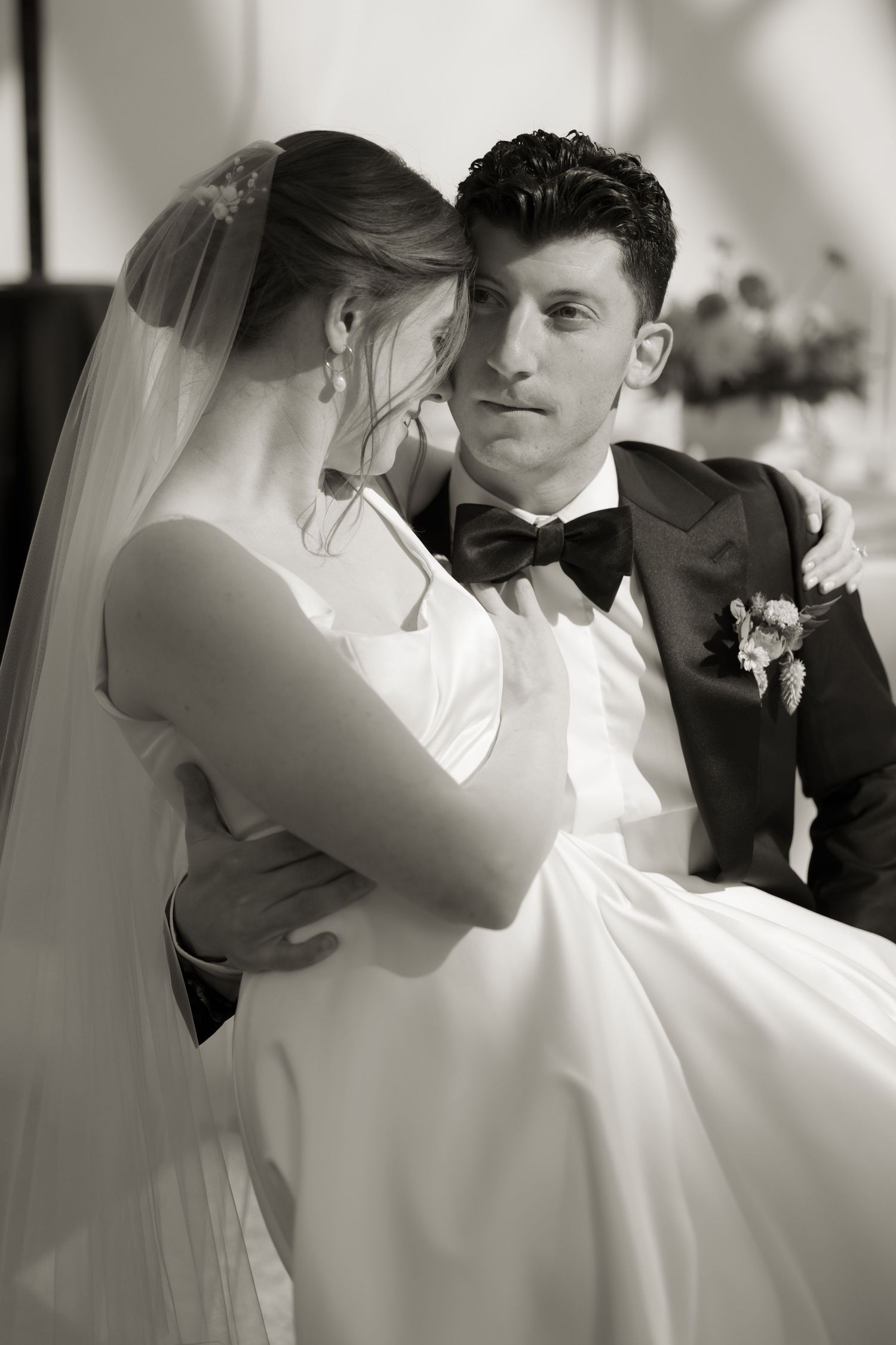 Black and white portrait of newlyweds sharing an intimate embrace.
