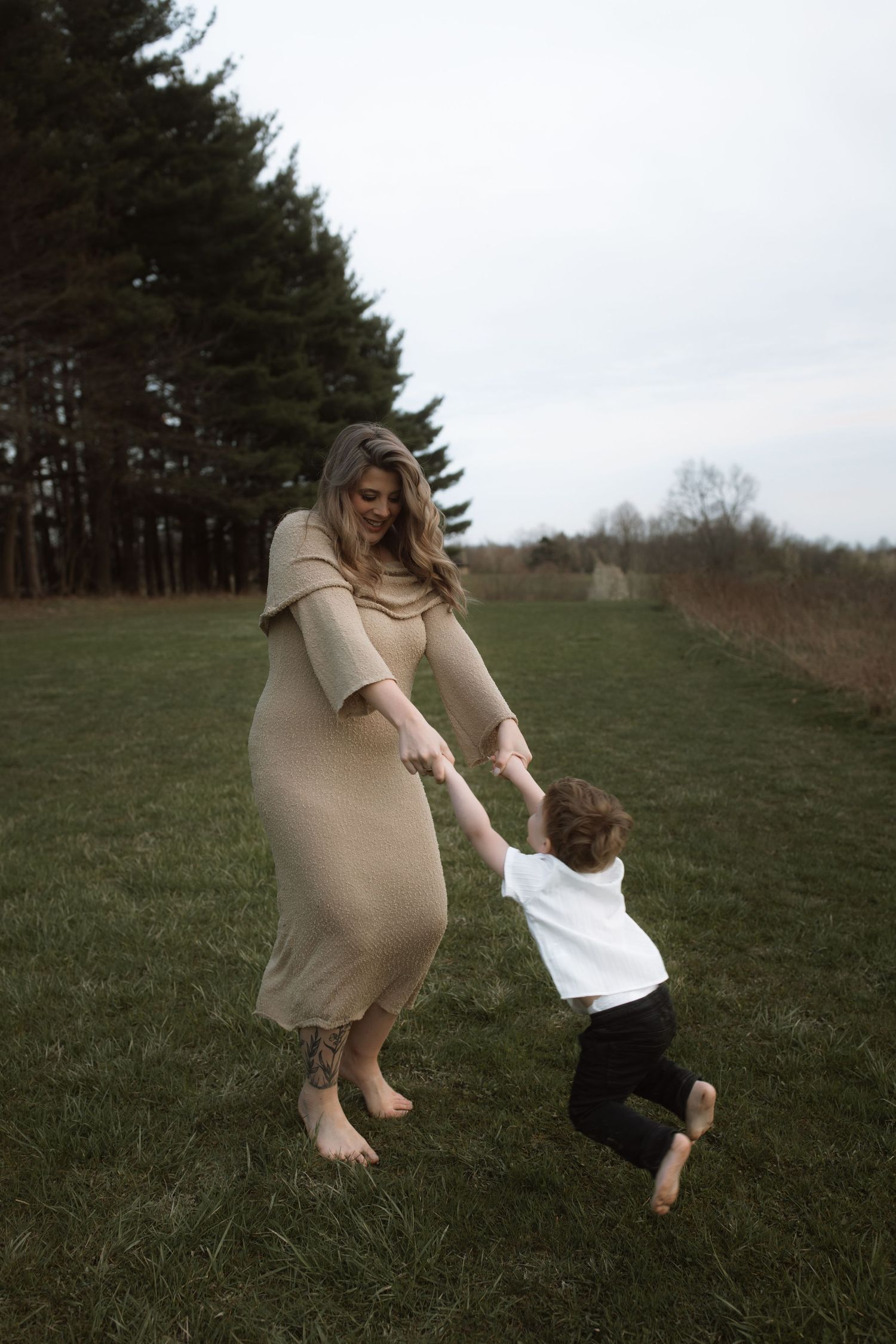 A playful moment captured of dancing together on a grassy field.