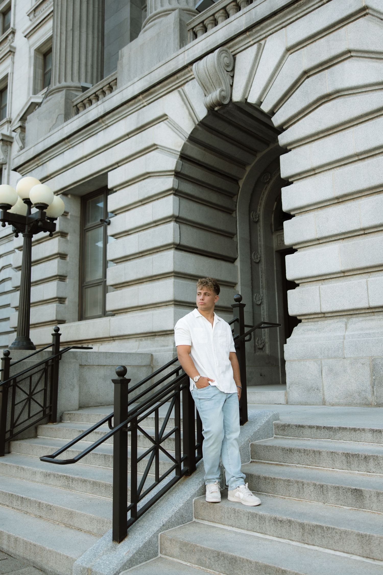 A sequence showing someone descending ornate stone steps outside a historic government building.