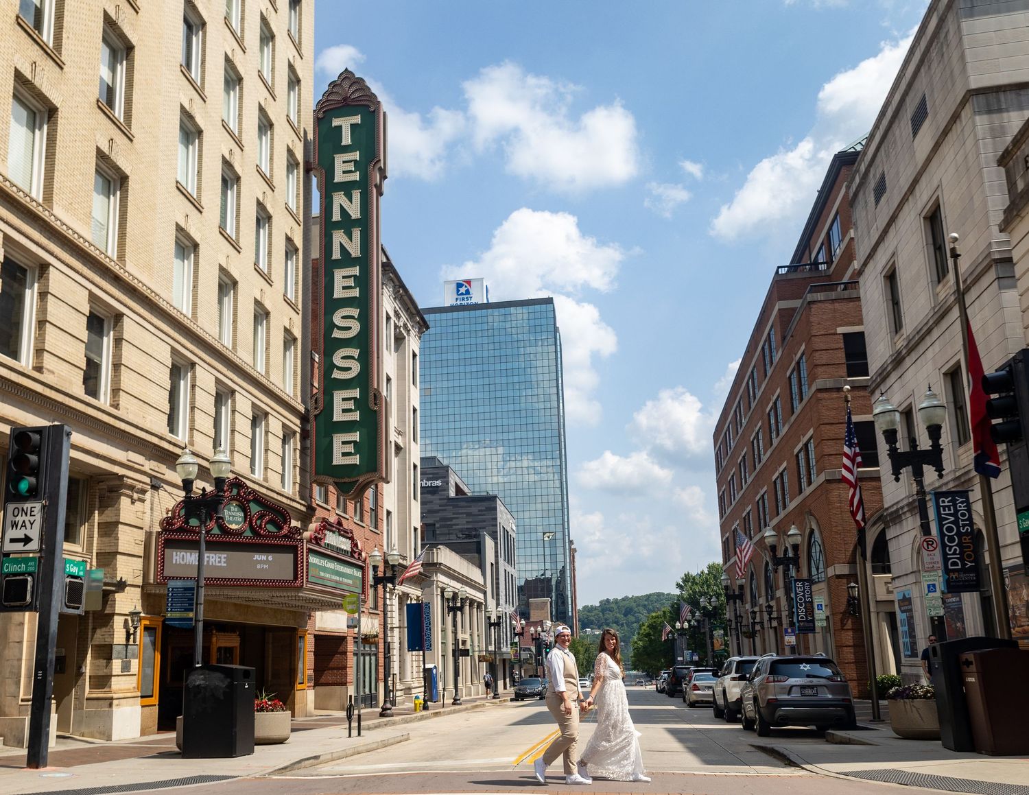 Historic Tennessee Theatre on Gay Street in downtown Knoxville with modern glass buildings and classic architecture on sunny day.
