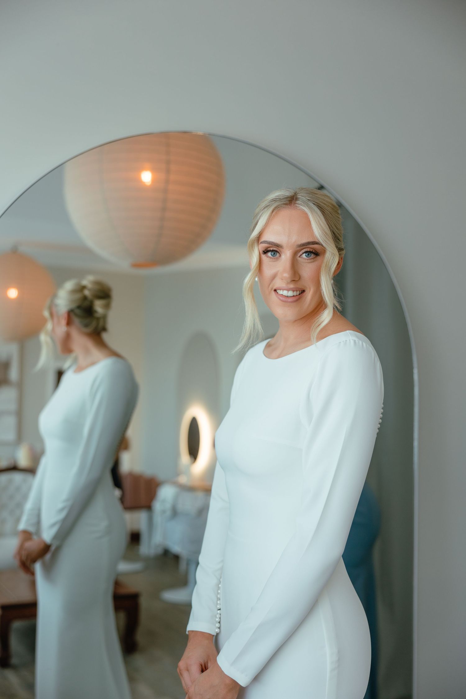 Elegant bridal preparation scene with soft lighting and paper lantern decor.
