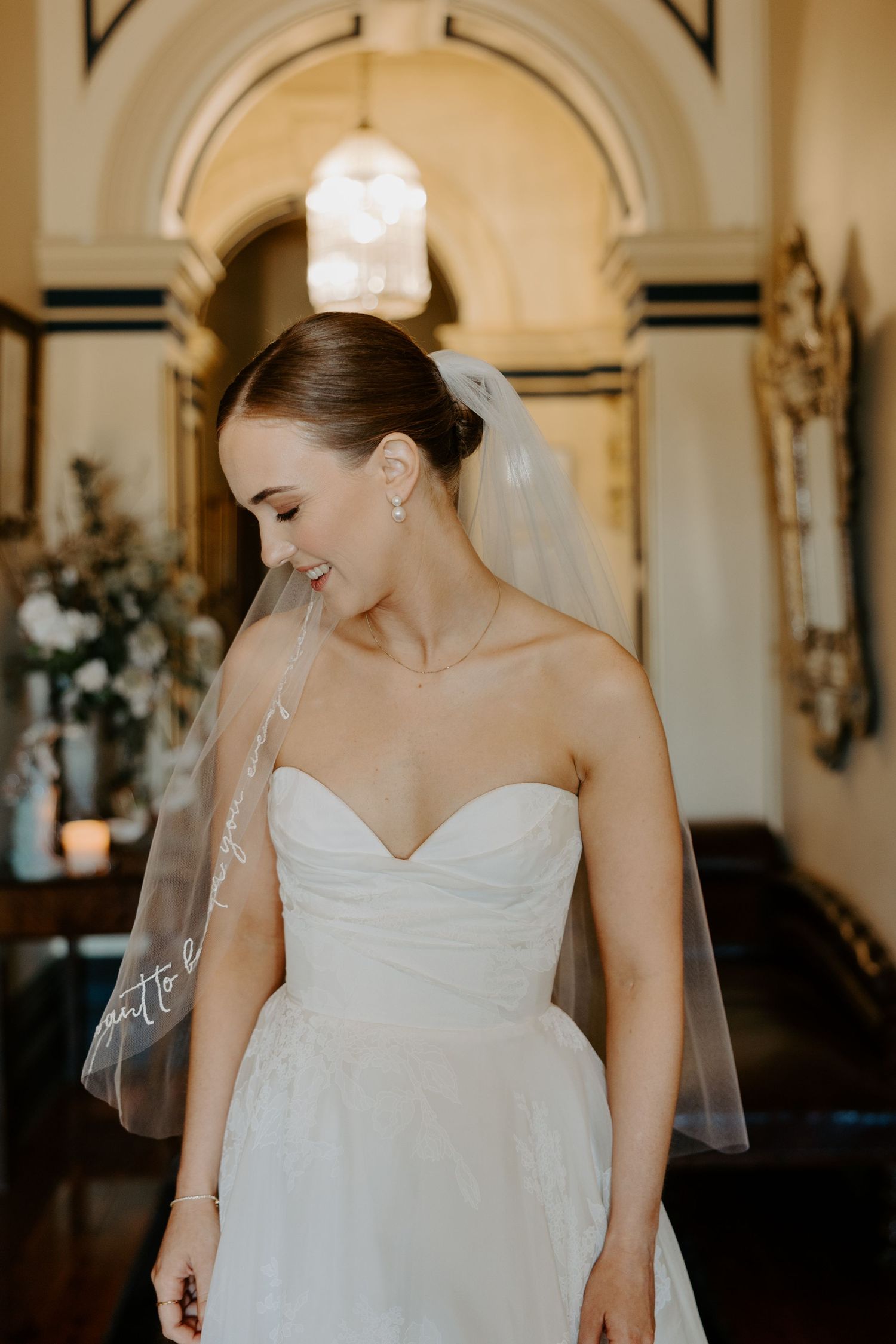A strapless white wedding gown with sweetheart neckline in an elegant indoor setting.