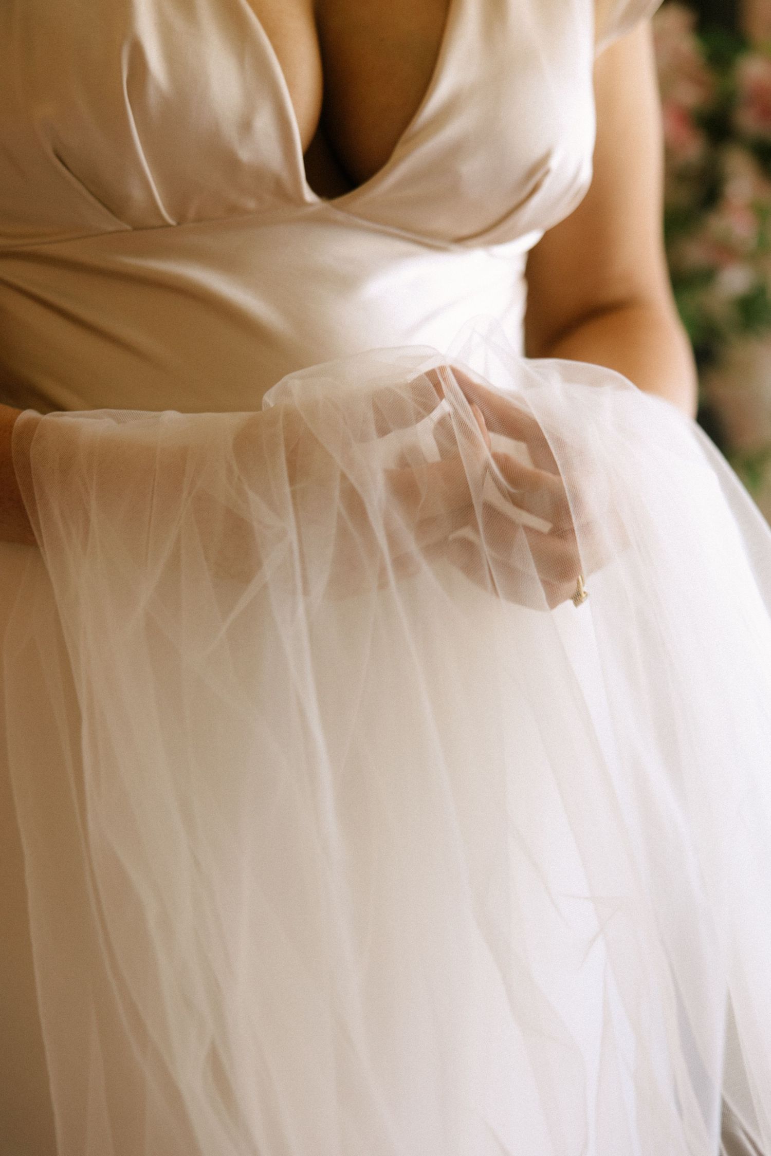 Detail shot of white tulle wedding dress fabric and sweetheart neckline.