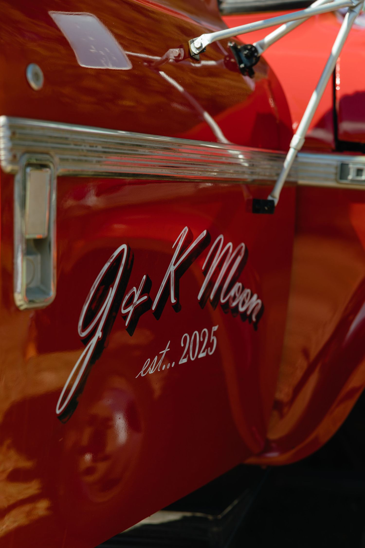 Close-up of red vehicle with signature detail reading J&K Moon.