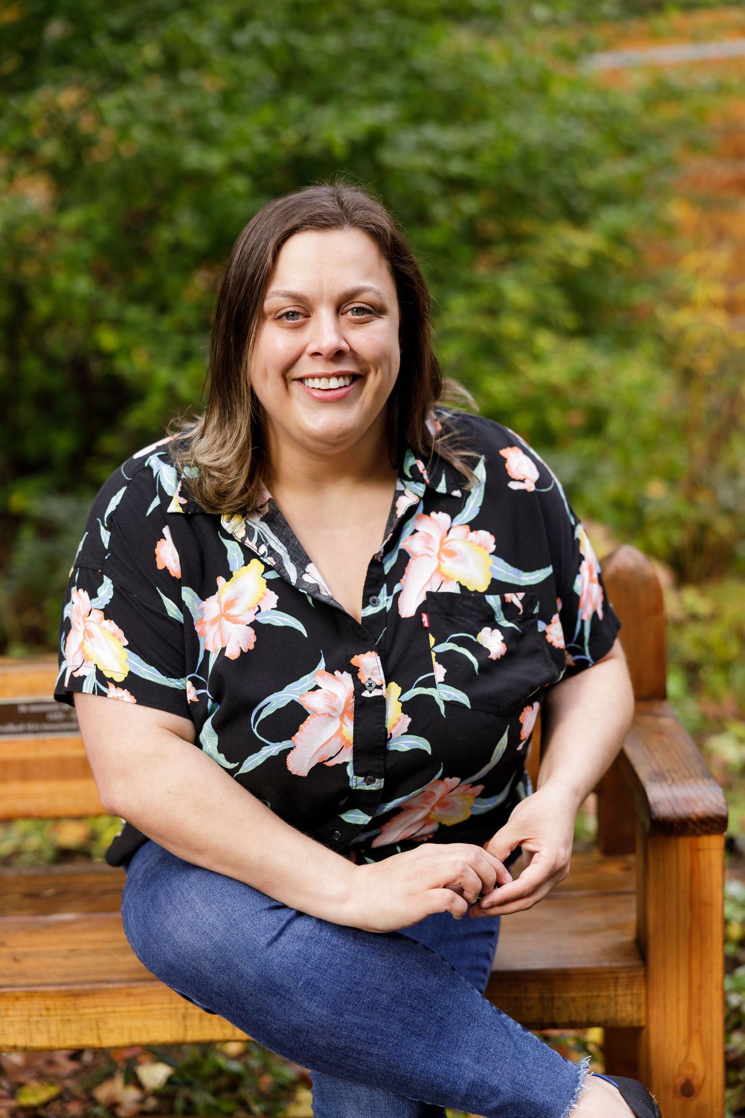 Savannah Rojan founder of scribbles Hub a systems analysis for business owners sitting on park bench branding headshot in Seattle, WA