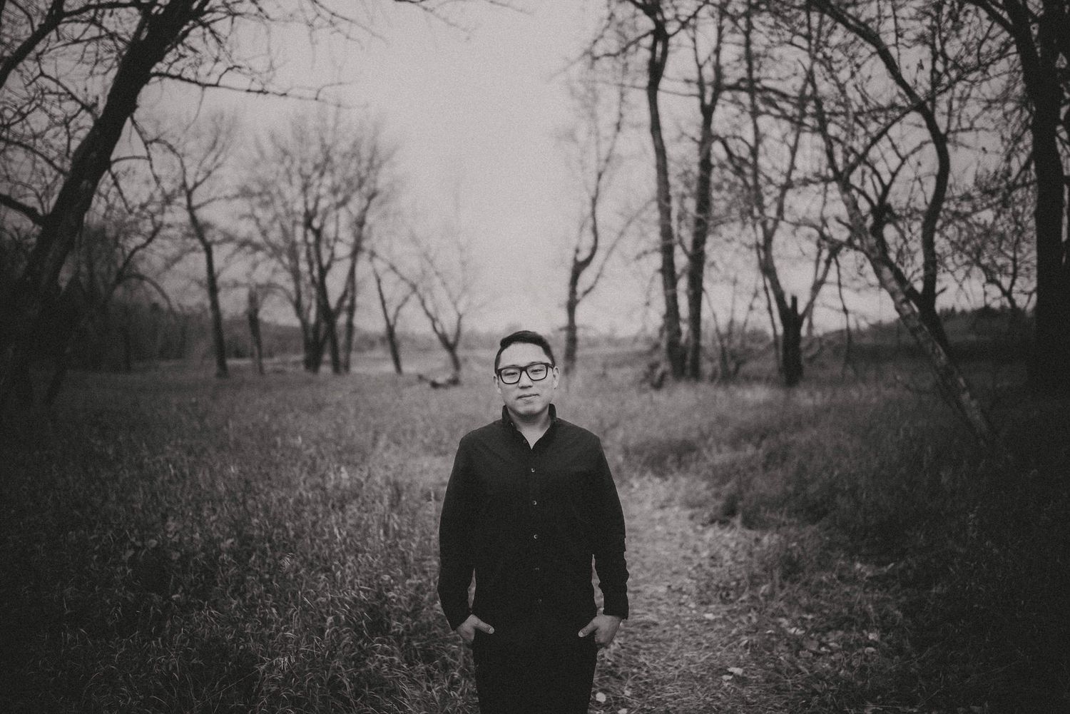 Calgary wedding photographer Ted Kim smiling in natural light portrait | Capturing romantic weddings in Banff, Canmore, and beyond.