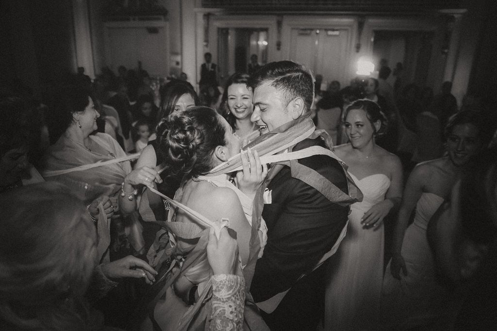 Bride and groom sharing a joyful moment during wedding reception dinner | Calgary wedding reception photography.