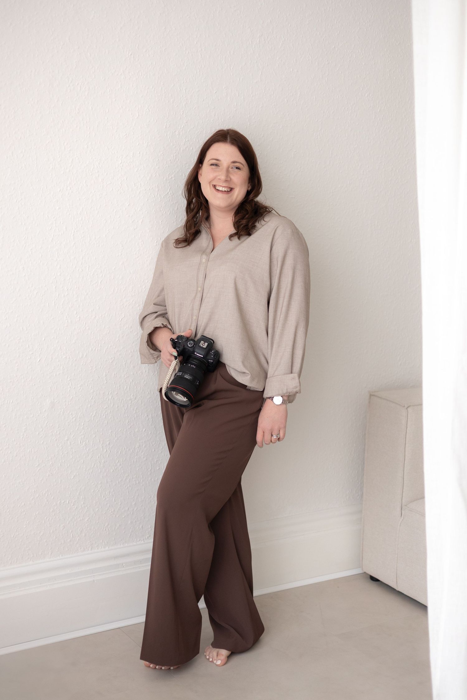 Portrait session in minimalist studio setting with professional camera equipment.