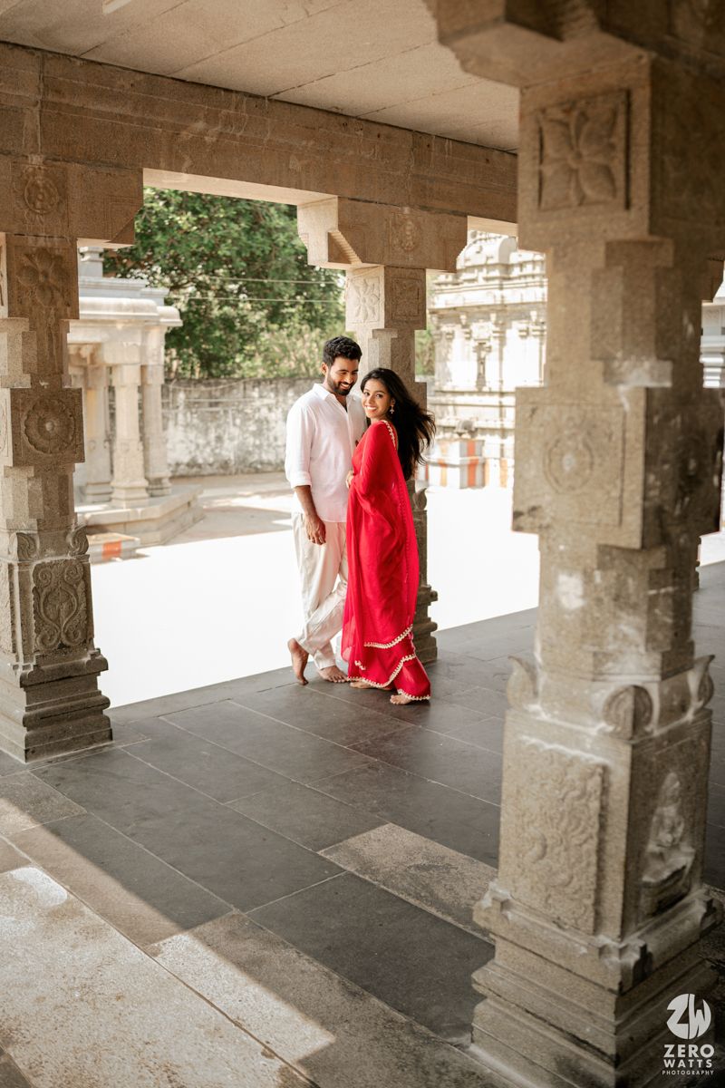Stone pillared corridor with natural light streaming through architectural elements during photoshoot.