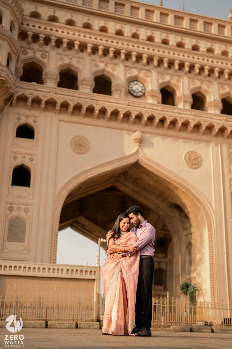 A romantic photoshoot at a grand historic palace archway with ornate architectural details and warm lighting.