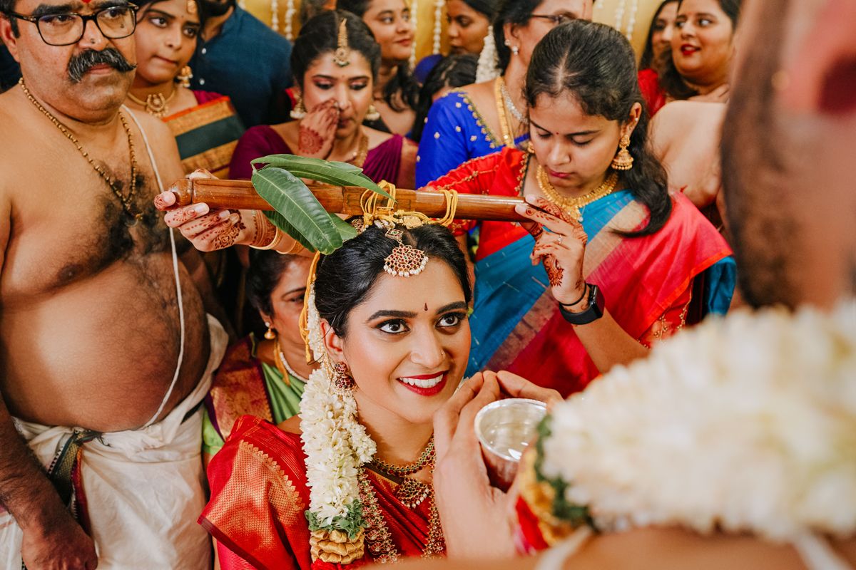 Traditional wedding ritual with family members performing blessings during an Indian ceremony.