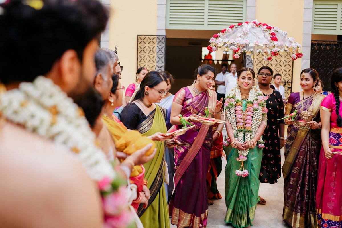 Festive wedding celebration with guests in colorful sarees gathered for traditional ceremonies.