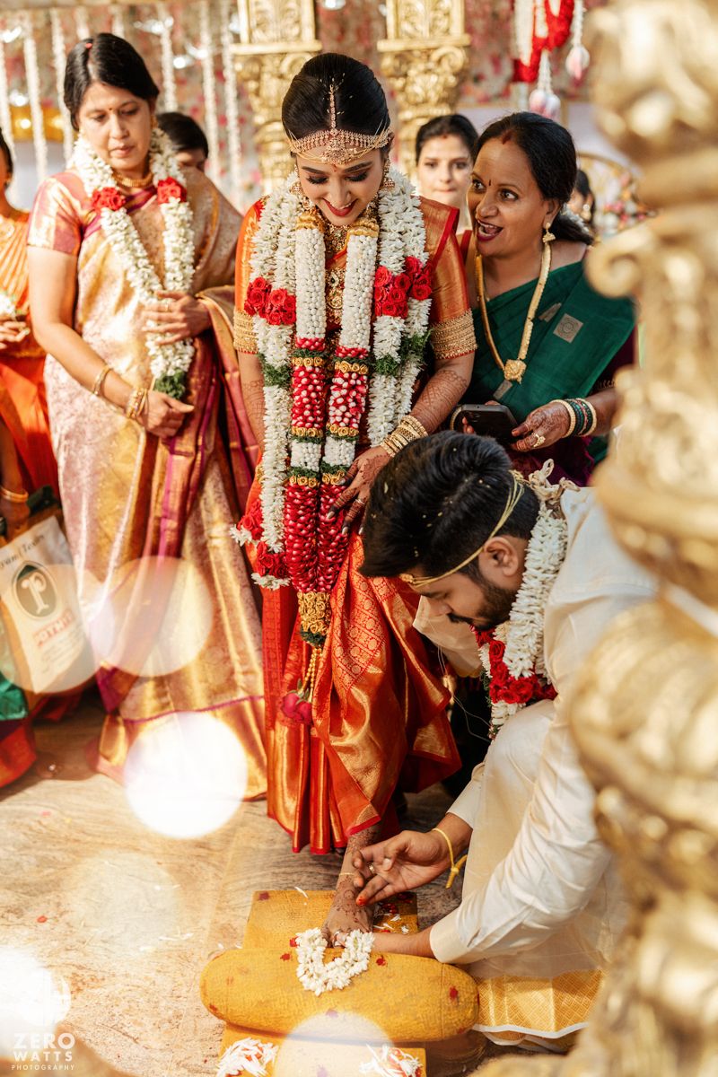 Traditional Indian wedding ceremony showing ritual practices being performed with vibrant decorations and attire.
