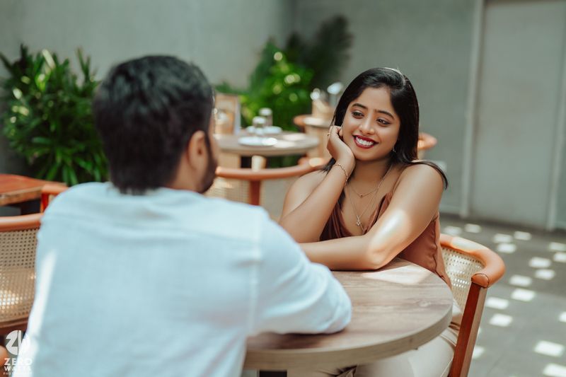 Intimate moment captured at a trendy cafe with modern decor and natural lighting.