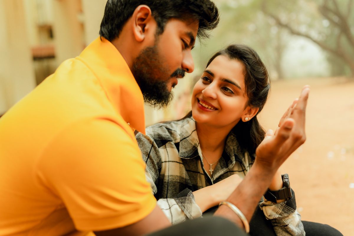 A candid moment showing two people sharing a laugh and intimate conversation.