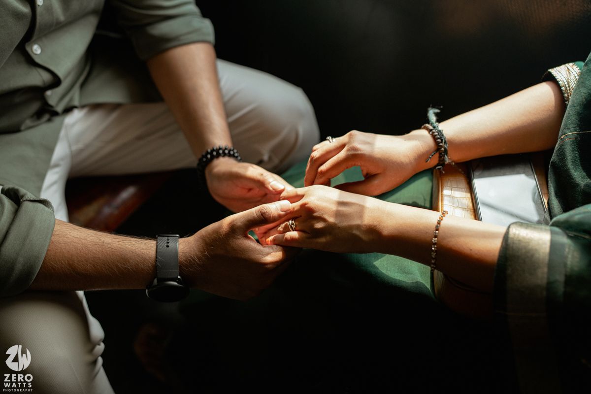 Close-up shots of hands touching and interacting in atmospheric lighting.