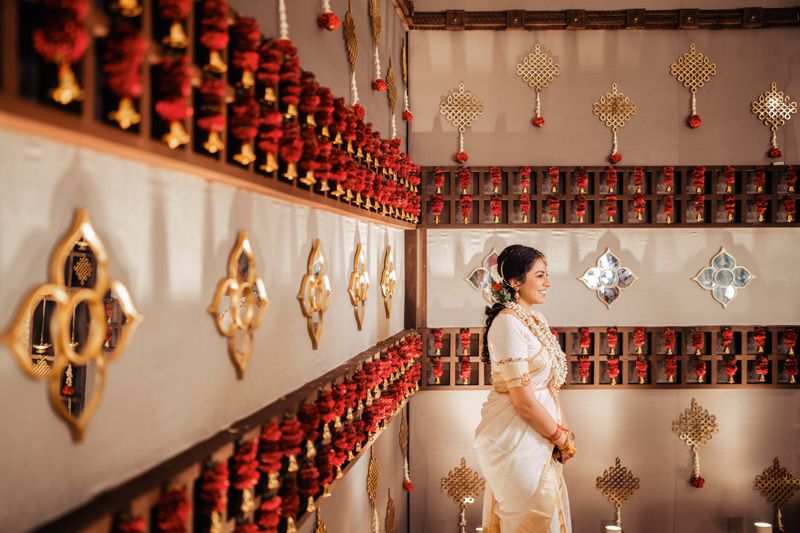 A traditional temple interior adorned with red hanging lanterns and golden wall decorations creating a sacred atmosphere.