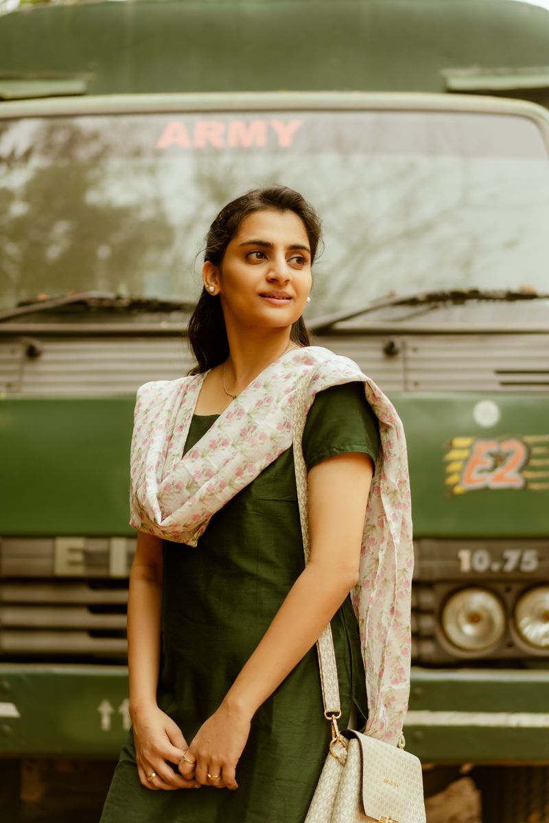 A portrait in front of a military vehicle showing traditional Indian attire and dress.