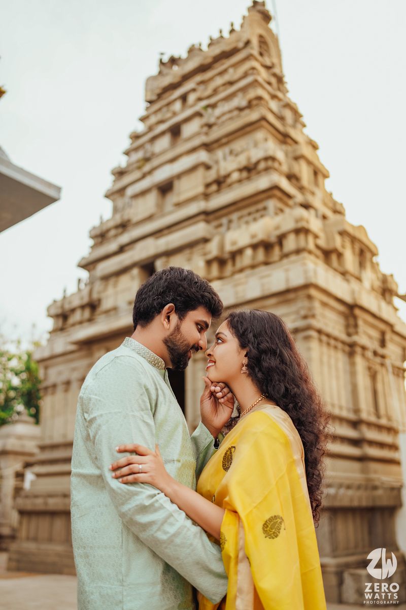 Traditional South Indian temple architecture serves as backdrop for romantic couple photo shoot.