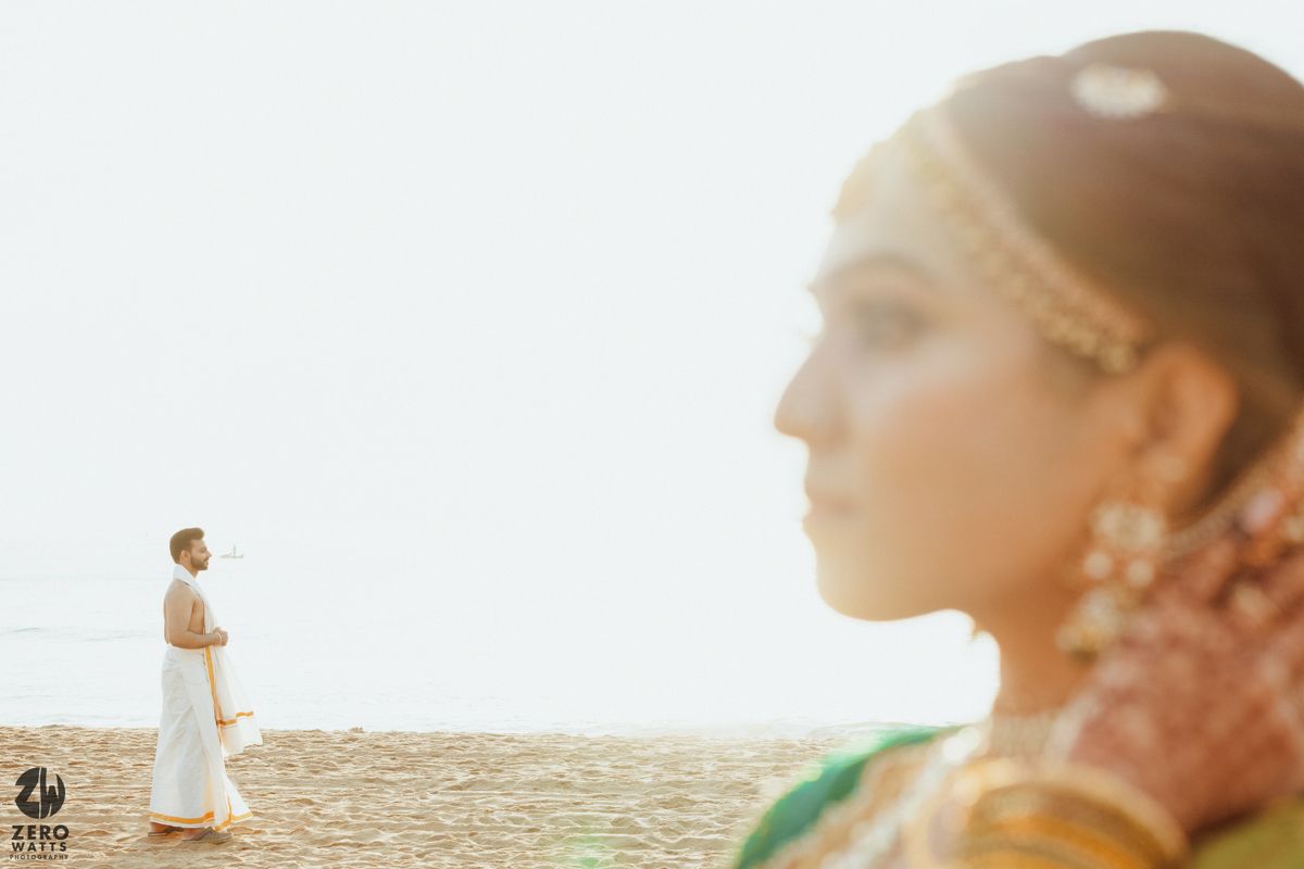 Artistic wedding photo with silhouette against beach backdrop.
