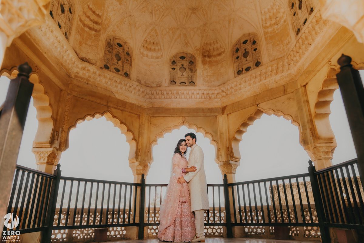 Ornate sandstone domed pavilion with intricate archways and carved details at a palace in Rajasthan, India.