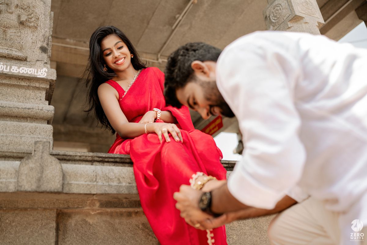 Romantic poses captured in soft focus along historic stone colonnade walkway.