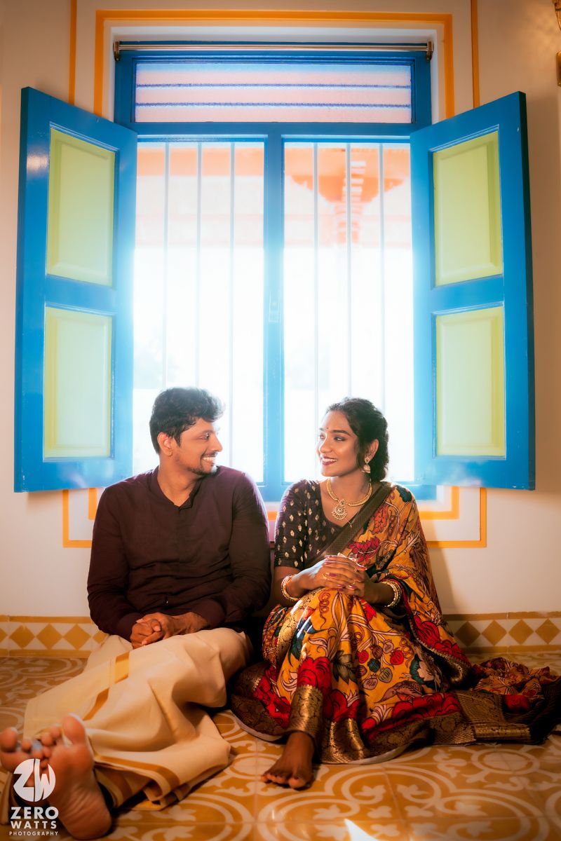 Interior scene with bright blue window frames and yellow walls in traditional Indian style.