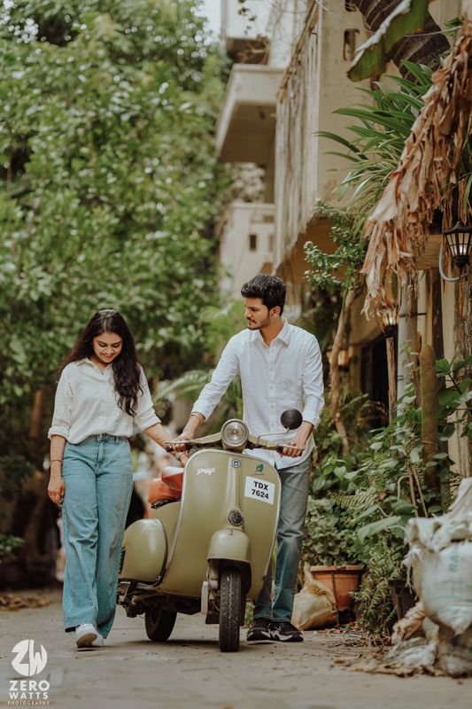 Vintage scooter photoshoot in a garden setting with lush greenery and rustic pathway.